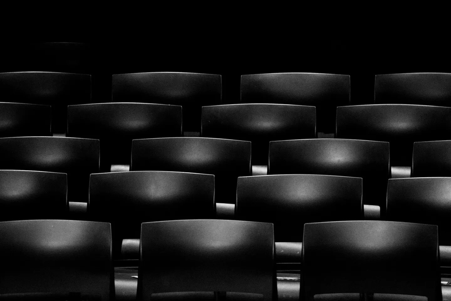 Rows of empty seats in a dim movie theater