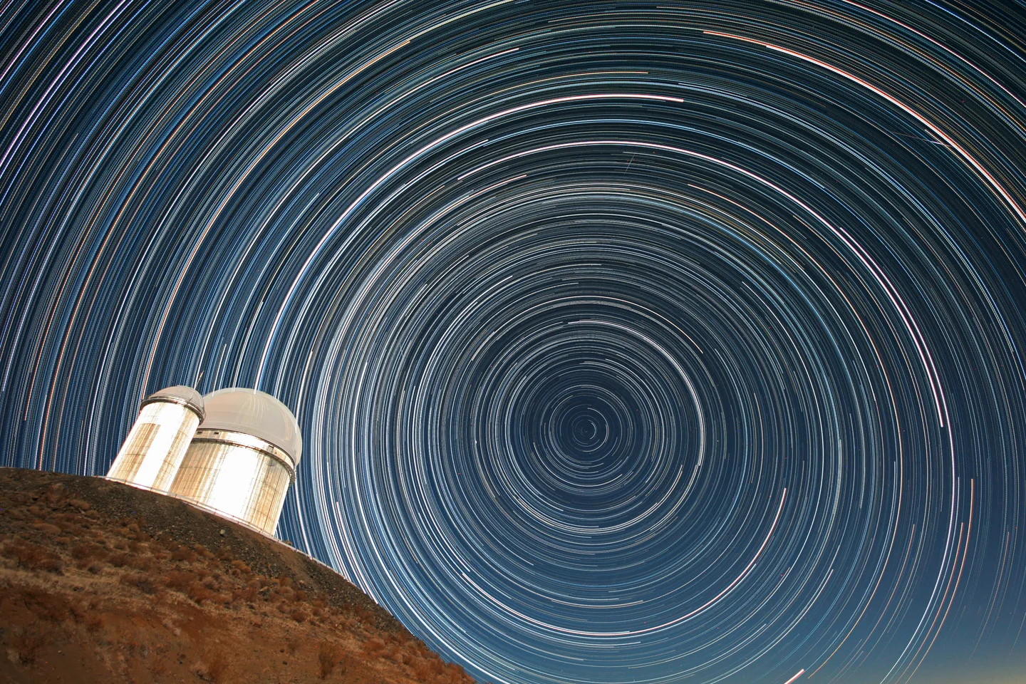 Star trails in the night sky above the dome of ESO’s 3.6-metre telescope at La Silla