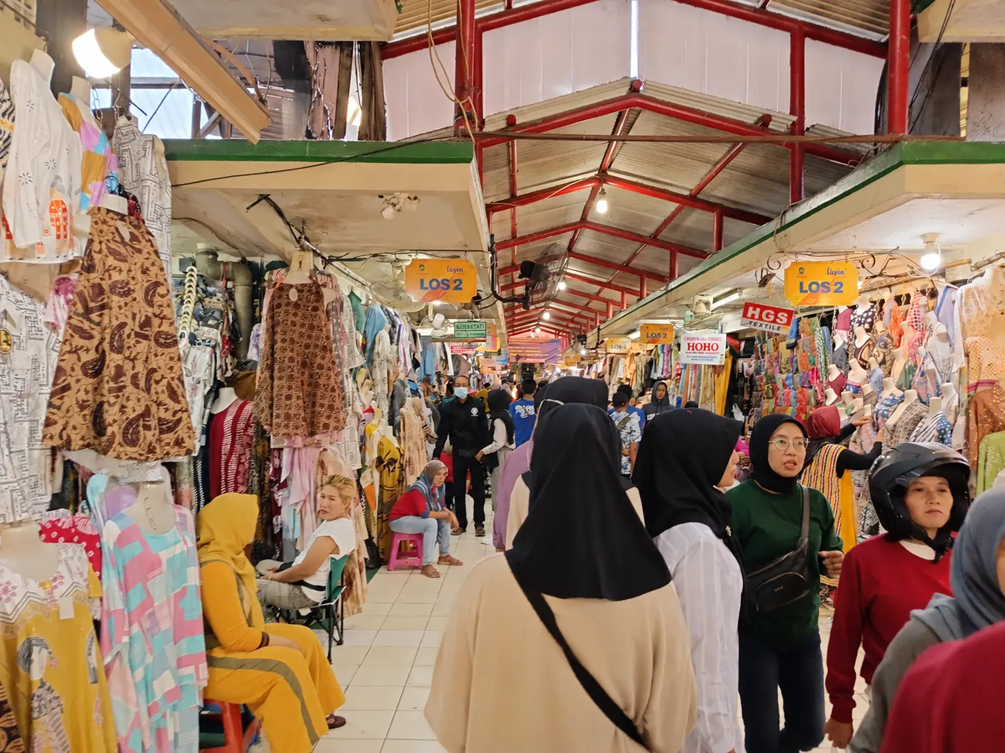 AI-adapted illustration of a clothing-market aisle in Yogyakarta