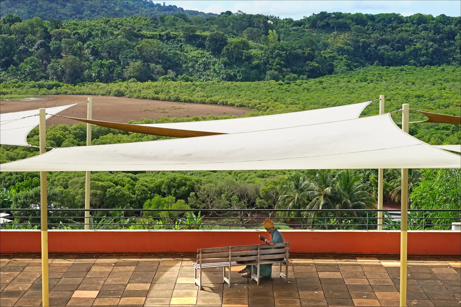 Terrace at the university centre in Dembéni, Mayotte, overlooking a wooded landscape.