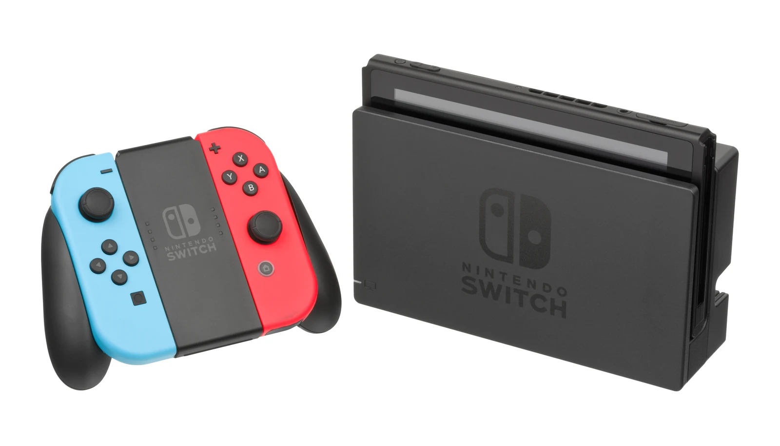Original Nintendo Switch in its dock beside neon blue and red Joy-Con controllers attached to a grip.