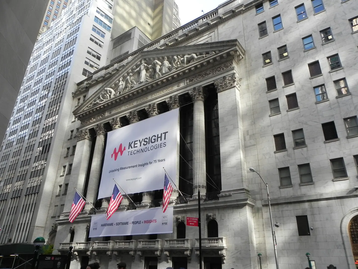 The New York Stock Exchange facade with American flags and a Keysight Technologies banner