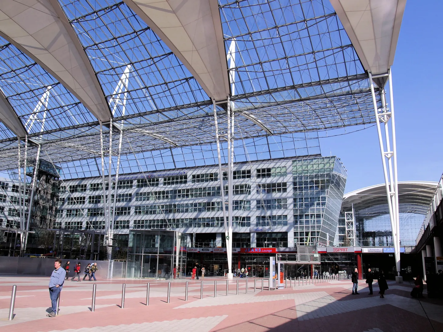 A glass and steel roof above an open plaza at Munich Airport