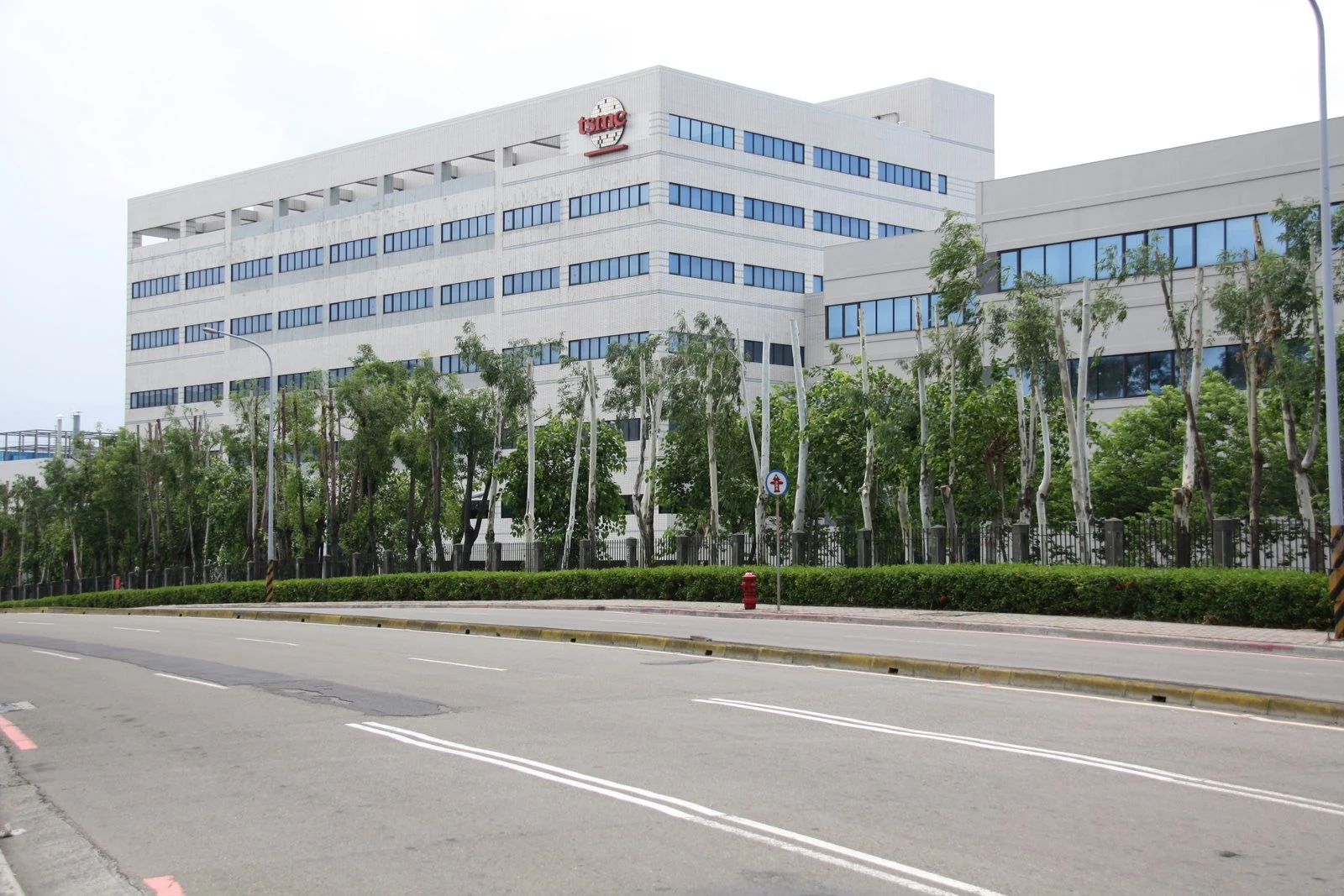 TSMC factory building in Hsinchu, Taiwan, with the TSMC logo visible above its windows.